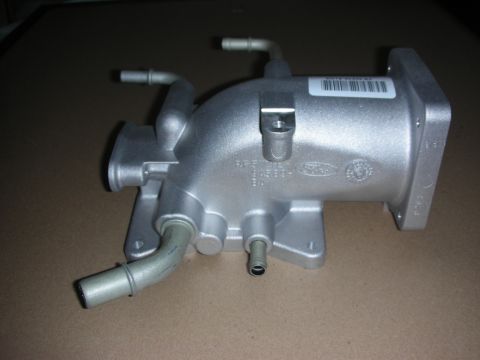 2004 Ford Crown Victoria - A silver Ford intake manifold with hoses and a barcode sticker is shown against a neutral background.