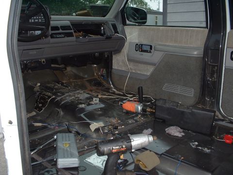 1994 GMC Suburban - Interior of a 1994 GMC Suburban showing disassembled dashboard and tools on the floor.