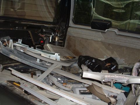 1994 GMC Suburban - The interior of the vehicle is in a state of disassembly, with various parts scattered around.