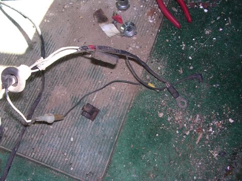 1978 Ford Bronco - A close-up view of a vehicle's wiring harness, showing various connectors and a ring terminal.