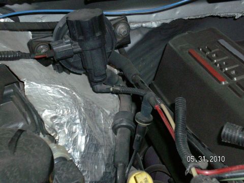 1996 Ford Bronco - Close-up view of engine bay components, including vacuum hoses and wiring.