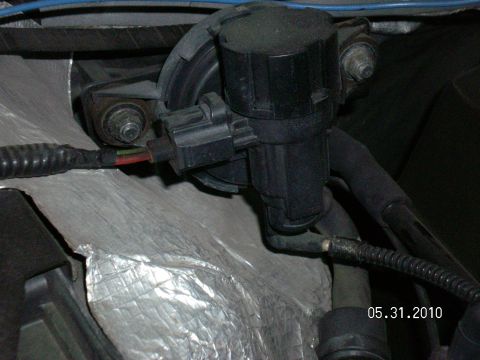 1996 Ford Bronco - Close-up view of an engine vacuum hose and electrical connector, dated 05.31.2010.