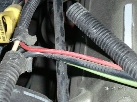 1996 Ford Bronco - A close-up view of various wires and hoses within a vehicle's engine compartment, with a date stamp of 05.31.2010.