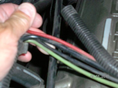 1996 Ford Bronco - Close-up of a hand holding electrical wires, with a date stamp and website visible.