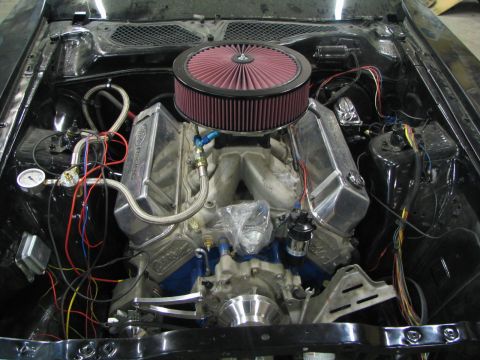 1971 Ford Mustang - Close-up view of a V8 engine with custom modifications and wiring.