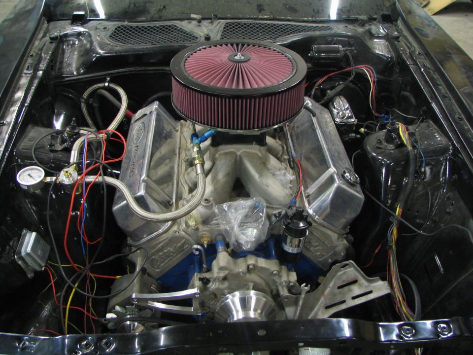 Engine bay with a V8 engine, chrome valve covers, and a large air filter