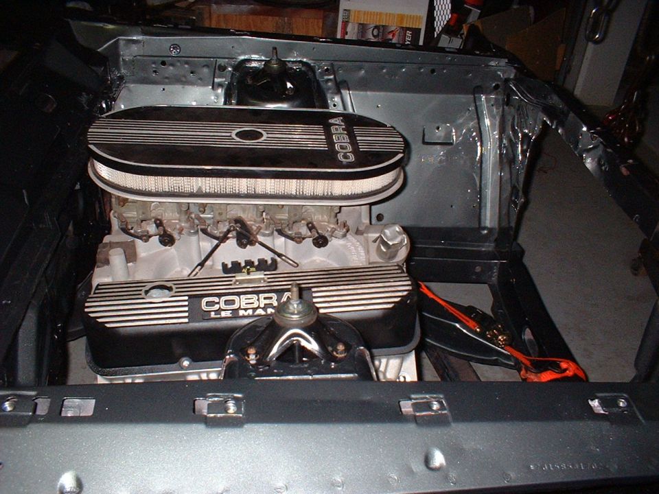 V8 with Cobra Le Mans valve covers and oval air cleaner in a stripped engine bay