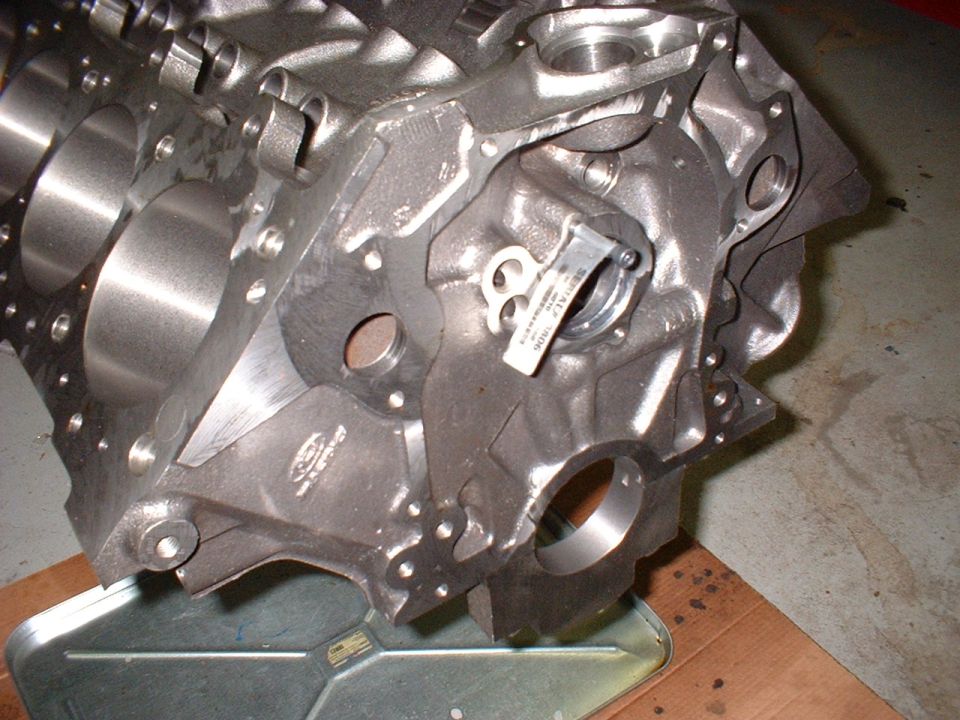 Close-up of an engine block with a tag attached to a bearing cap
