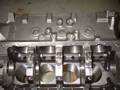 1956 Ford Crown Victoria - Close-up view of an engine block's crankshaft bearing saddles, revealing internal mechanical components.