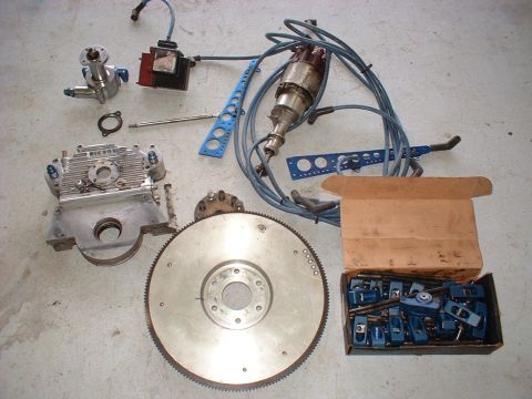 1956 Ford Crown Victoria - Various engine components are spread out on a concrete surface, suggesting a rebuild or upgrade project.