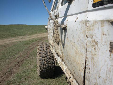 1992 Ford F-350 - Truck covered in mud after driving off-road on a sunny day.