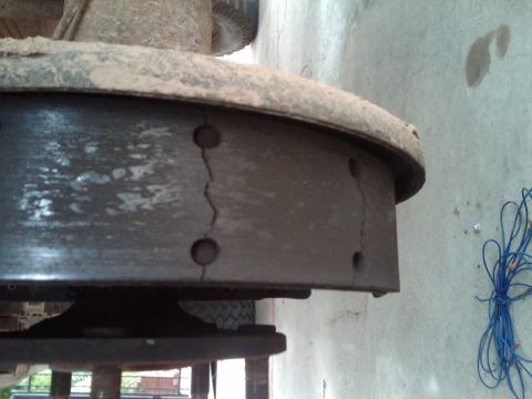 1982 Ford Bronco - A close-up view of a cracked brake shoe, part of a vehicle's braking system.
