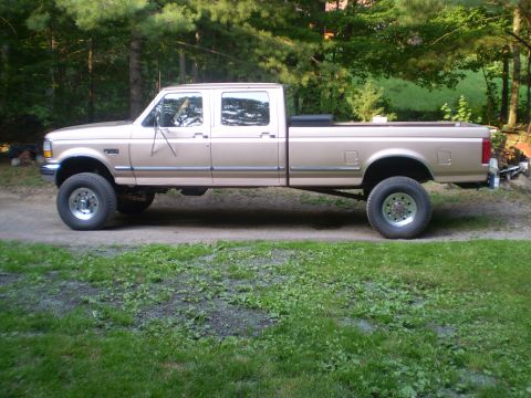 1979 Ford Bronco - This tan Ford F-250 Super Duty Crew Cab pickup truck is shown from the side, indicating a model year around 1992.