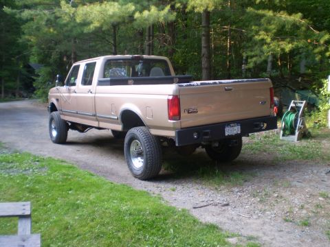 1979 Ford Bronco - This tan Ford F-350 pickup truck is shown from the rear three-quarter view, with the F-350 badging clearly visible.