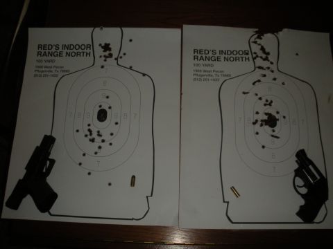 1996 Ford Bronco - Two paper targets show bullet impacts, with handguns placed beside each.