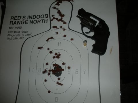 1996 Ford Bronco - A revolver rests on a target at Red's Indoor Range North, showing the results of target practice.