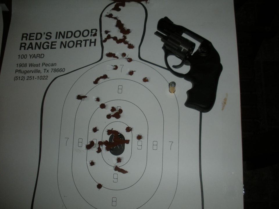 Revolver on a target with bullet holes