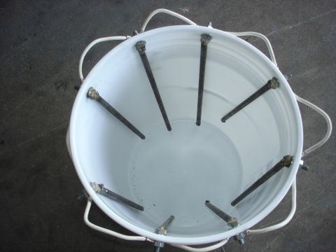 1979 Ford F-250 - Electrolysis setup in a bucket with rebar electrodes and wiring for rust removal.