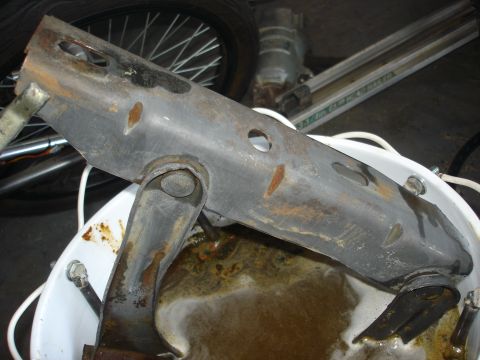 1979 Ford F-250 - Metal part undergoing electrolysis rust removal in a bucket.