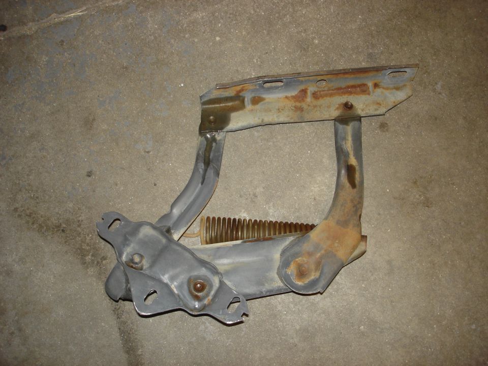 Hood hinge with spring, showing rust and wear