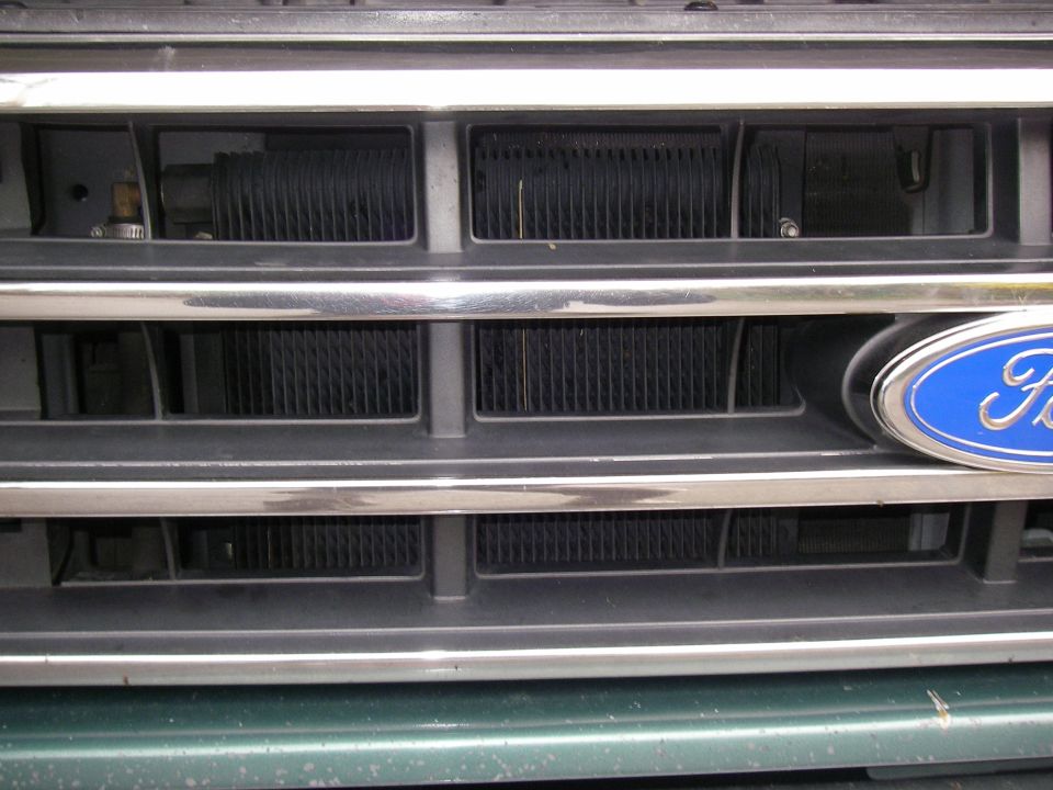 Ford oval emblem on chrome grille of a 1990 Ford Bronco
