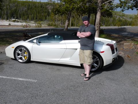 2006 Ford E350 - A man poses with a white convertible sports car in a scenic, wooded area.