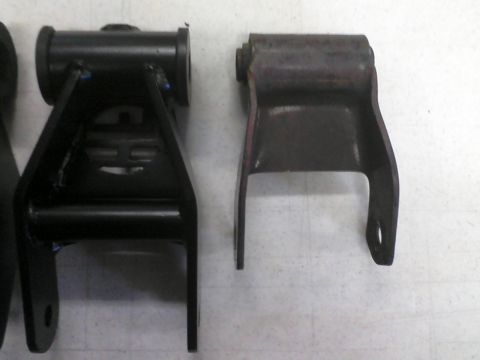 1993 Ford Bronco - Comparison of two leaf spring shackle brackets, one appears new and the other shows signs of rust.
