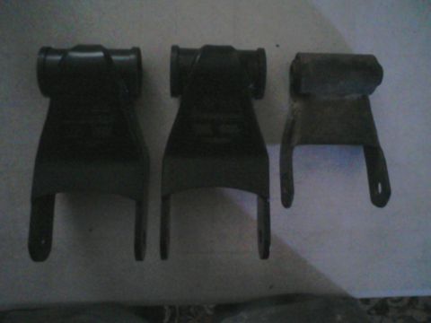 1993 Ford Bronco - Three leaf spring shackles are displayed, with two larger ones on the left and a smaller one on the right.