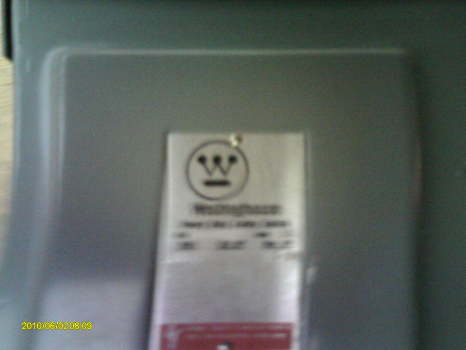 Silver label with Westinghouse logo and text on a gray surface