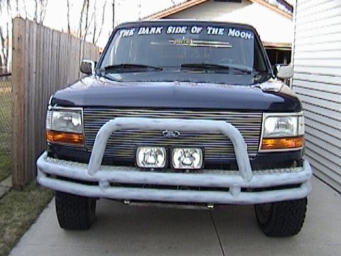1995 Ford Bronco - This Ford truck features a prominent brush guard and auxiliary lights on the front bumper.