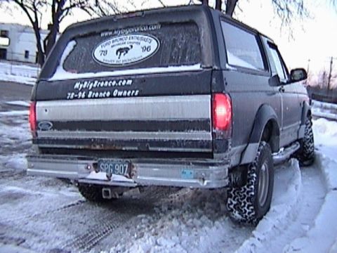 1995 Ford Bronco - This Ford Bronco, likely a 1996 model based on the sticker, is seen from the rear in a snowy environment.