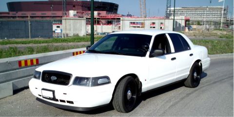 1998 Ford Crown Victoria - This white sedan has black steel wheels and a black grille, with construction in the background.