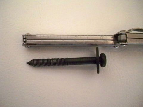 1994 Ford Bronco - Bolt and multi-tool shown for scale. The multi-tool has ruler markings up to 13 inches.