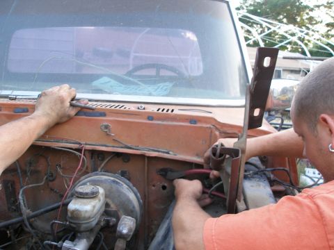 1969 Ford F-250 - Working on the engine bay of a classic truck, focusing on wiring and mechanical components.