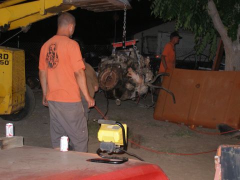 1969 Ford F-250 - Engine removal in progress, assisted by a crane and a loader.