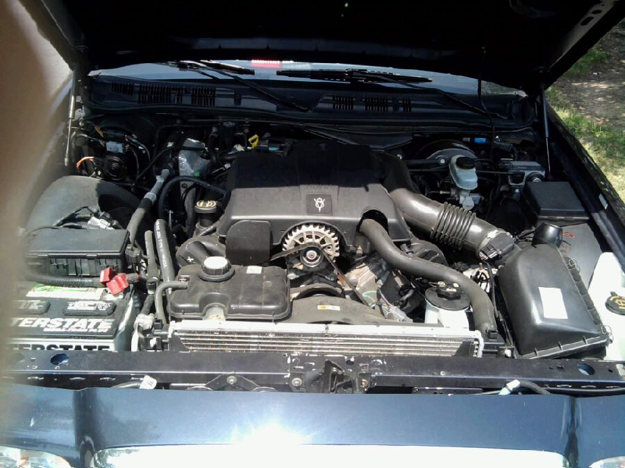2003 Ford Crown Victoria engine bay with V8 engine, battery, and radiator visible