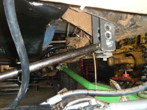 1978 Ford Bronco - Custom suspension parts and fuel tank are visible, with heavy equipment in the background.