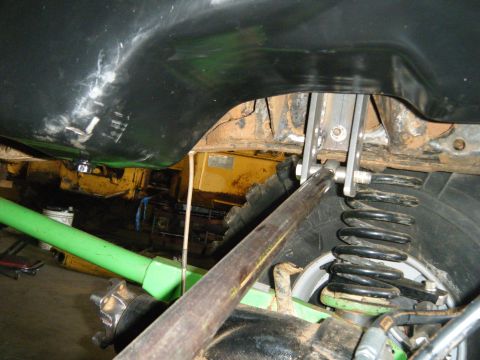 1978 Ford Bronco - Underside view of a vehicle's suspension and fuel tank, showing modifications.