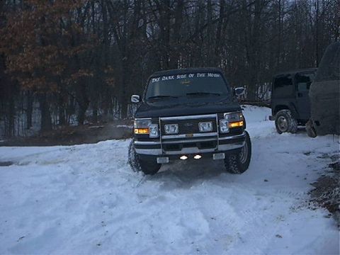 1995 Ford Bronco - Front view of a 1995 Ford Bronco driving in the snow.