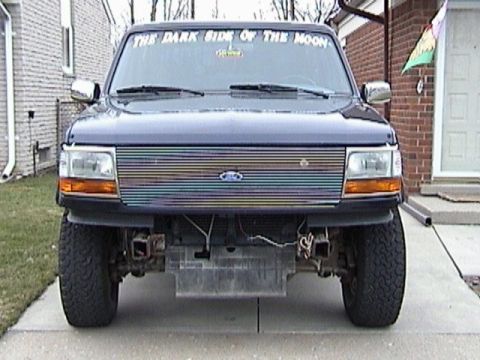 1995 Ford Bronco - This Ford truck features a custom grille and a Pink Floyd reference on its windshield.