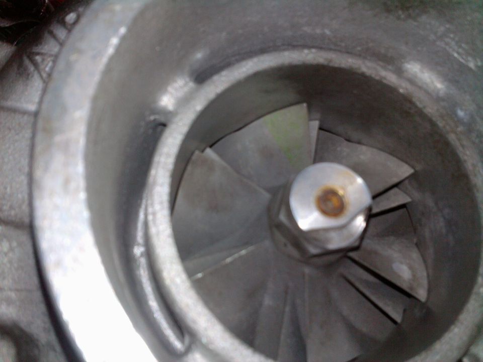 close-up of a turbocharger's compressor wheel with angled blades