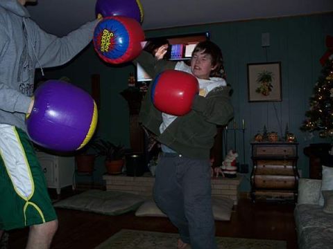 1988 Ford Bronco - Two people are engaged in a playful boxing match using oversized inflatable gloves.