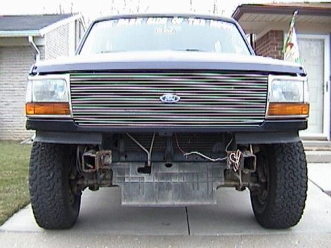 1995 Ford Bronco - Front view of a 1995 Ford Bronco a chrome grille and visible aftermarket bumper mounts.