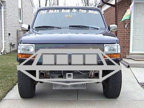1995 Ford Bronco - A truck is parked in a driveway, showing its front end with a large, aftermarket bumper assembly.