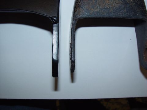 1993 Ford Bronco - Comparison of a new black metal bracket next to an old, rusted bracket.