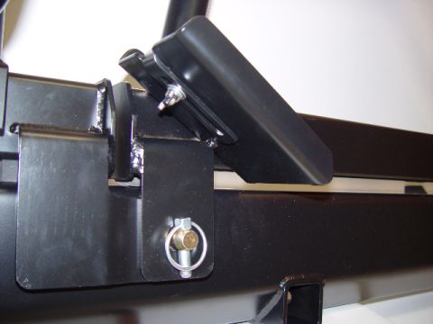 1993 Ford Bronco - Close-up view of a black metal bracket assembly with a clevis pin.