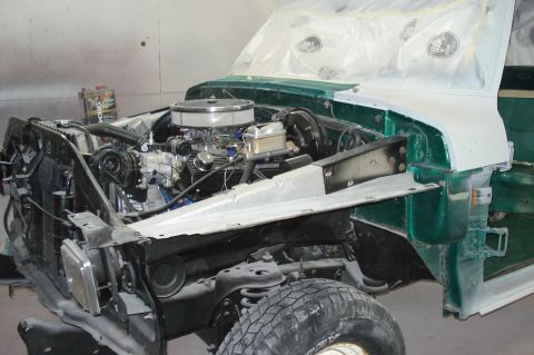 1979 Ford F-150 - Engine bay of a 1979 Ford F-150 undergoing restoration work, showing exposed components and green body panels.