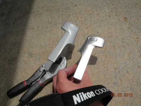 2000 Porsche Carrera - Two silver car door handles are shown, one held by a hand with a camera strap.