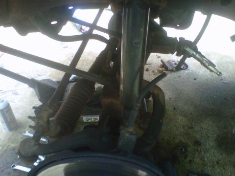 1981 Toyota Hilux - A close-up view of the undercarriage of a vehicle, showing suspension components like the shock absorber and springs.