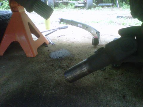 1981 Toyota Hilux - A vehicle's leaf spring and exhaust pipe are visible, along with tools and a jack stand.